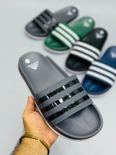 AD - Adilette Slides featuring a sleek design, perfect for casual wear in Pakistan.

