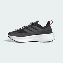 BlackGrey Black Orange Adidas Ultraboost 5 TR Shoe with white sole on a light gray background