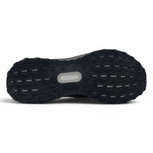 The black textured outsole of a Triple Dark Brown Adidas Ultraboost 5 TR Shoes in dark brown and black showing a central translucent AirTruck sole window, photographed from a top-down view on a white background.