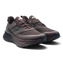 A pair of Triple Dark Brown Adidas Ultraboost 5 TR Shoes in dark brown and black, shown from a three-quarters angle on a white background.
