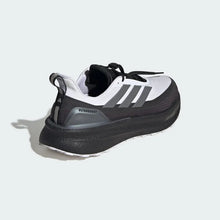 A single White Core Black Adidas Ultraboost 5 TR Shoe shown from a three-quarters rear angle, featuring a white and dark gray upper with black laces and a black midsole, set against a light gray background with a soft shadow.