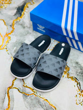 Gray strap with printed logo pattern on Adidas Walkfree Unisex Printed Fur Room Slippers 2.0