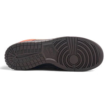 The outsole of a Nike sneaker, showing a dark brown textured rubber tread with a subtle embossed Nike logo in the center, against a plain white background.