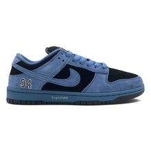 A Nike x Supreme Dunk sneaker in a light blue suede and navy blue mesh combination, featuring the number 94 on the heel and 'Supreme' printed on the midsole, shown against a plain white background.