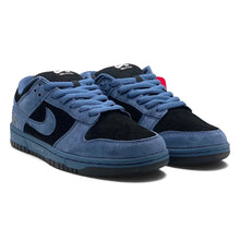 A pair of Nike Dunk Low sneakers in blue suede and black suede, featuring a blue midsole and black outsole, shown on a white background.